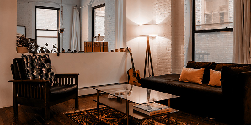 Apartment-Lamp Photo of a stylish apartment living room illuminated by a single floor lamp plugged into a switch controlled outlet.